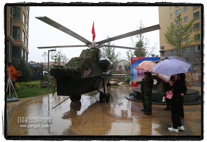 小區(qū)突然出現(xiàn)“飛機(jī)坦克”，其中殲15艦載戰(zhàn)斗機(jī)一架、99式主戰(zhàn)坦克一輛、武直-10武裝直升機(jī)一架，吸引了眾多市民雨中圍觀、合影。